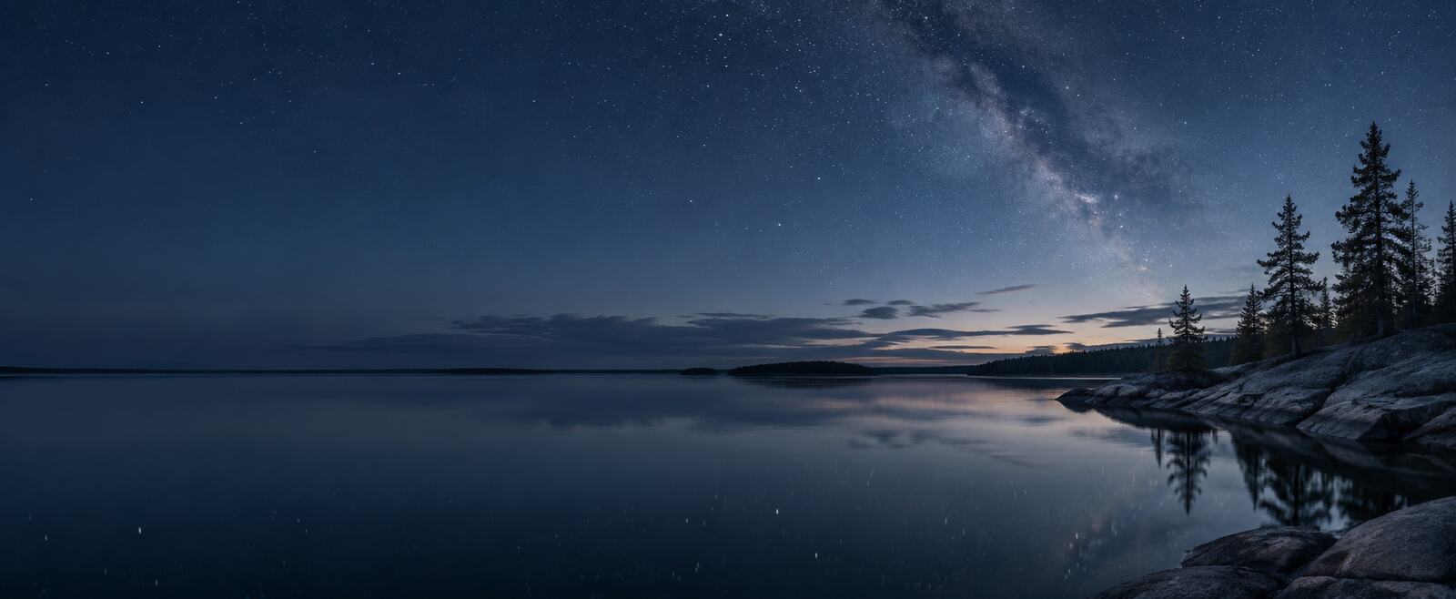 A quiet northern lake beneath a starry sky